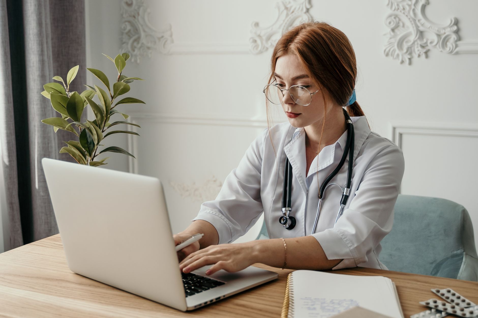 Healthcare professional using a laptop for revenue cycle management workflows