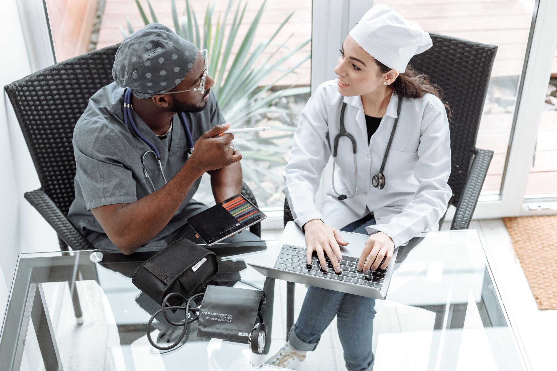 Healthcare team collaborating around a laptop on revenue cycle workflows